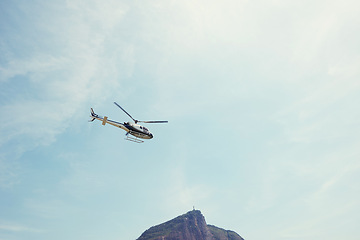 Image showing Drone, view and helicopter in a blue sky for travel, adventure or low angle transportation. Flying, freedom or aircraft in nature for search and rescue, cargo or emergency, service and assistance