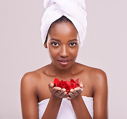 Image showing Portrait, skincare and black woman with red petals, cosmetics and dermatology on a white studio background. Face, African person and model with natural beauty and grooming with treatment and luxury