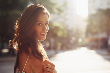 Image showing Portrait, smile and woman with sunshine, city and happiness with weekend break and travelling. Face, person and New York with girl and summer with journey and adventure with lens flare and confidence