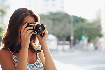 Image showing Woman, photography and city street with camera for photo, memory or capturing outdoor moment. Female person, tourist or photographer taking picture with lens for sightseeing or travel in urban town