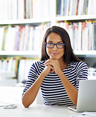 Image showing Portrait, happy woman and student at table in home for remote learning, study or distance education on laptop in house. Face, glasses and smile of person at desk on computer in Brazil in apartment