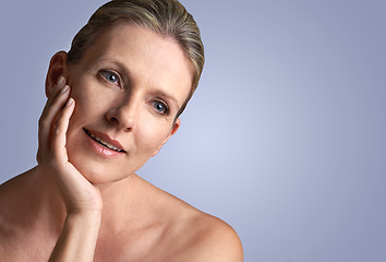 Image showing Face, beauty and space with mature woman in studio on gray background for aesthetic wellness. Skincare, relax and mock up with natural skin person at spa for antiaging cosmetics or treatment