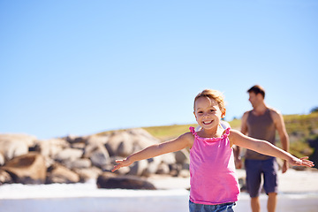 Image showing Happy, portrait and little girl flying on beach with blue sky for fun summer, holiday or outdoor weekend in nature. Female person, child or kid with smile for playful day by the ocean coast on mockup