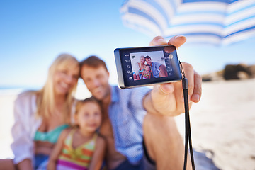 Image showing Happy family, beach and selfie with camera for photography, picture or moment in outdoor nature. Mother, father and child with smile for photo, capture or bonding memory together on the ocean coast