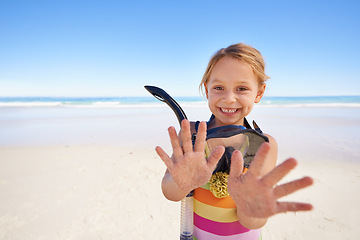 Image showing Girl, portrait and hands for goggles at beach, swimming and equipment for snorkeling on holiday. Female person, child and happy on tropical vacation in outdoors, sand and blue sky for mockup space