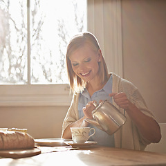 Image showing Pouring, tea and happy woman in home for morning, calm routine and drink on table. Girl, relax and coffee break with food, snacks or teapot in hands for breakfast preparation on holiday or vacation