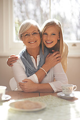 Image showing House, hug and girl visit mom for breakfast, coffee and daughter with senior, retirement and embrace. Female person, smile and happiness with mother in family home, elderly and woman in dining room