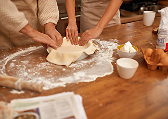 Image showing Hands, food and couple baking in kitchen of home together closeup with ingredients for recipe. Cooking, dough or flour with husband and wife in apartment for fresh pastry preparation from above