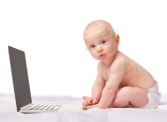 Image showing Baby, laptop and studio for entertainment, portrait and games in child development and progressive technology. Infant, happy and newborn for home, diaper and white background for playful time