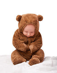 Image showing Growth, development and portrait for baby in studio with bear costume or pajamas against white backdrop. Boy, child or toddler with teddy clothes and adorable and cute for bed, cuddle and cozy