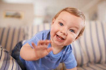 Image showing Playing, playful and portrait of baby in sofa or home for fun, growth or learning alone in living room. Energy, boy or face of a curious male kid on couch for child development or crawling in a house