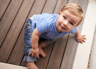 Image showing Floor, above or portrait of baby in home for fun playing, happiness or learning alone on porch. Relax, boy or face of a toddler on ground with smile for child development or growth in house top view