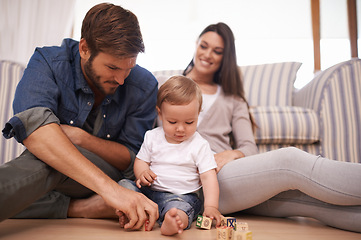 Image showing Father, baby and building blocks on floor, support and growth or development toys for teaching play in living room. Happy family, dad or interactive game for child or learning of motor skills in home