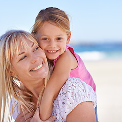 Image showing Child, mother and happy kid on beach for holiday, summer or vacation with piggyback at sea. Face, mom and smile of girl at ocean for adventure, travel or family bonding together outdoor in nature