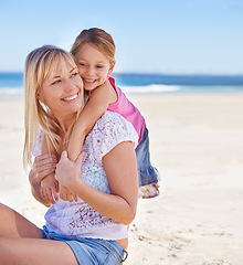 Image showing Piggyback, mother and happy kid on beach for holiday, summer or vacation on mockup space. Sea, smile and mom carrying girl child at ocean for adventure, travel or family bonding together outdoor