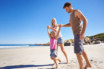 Image showing Love, holding hands and happy family at a beach with swing, support and care while bonding in nature. Freedom, travel and kid with parents at the ocean for morning games, fun or adventure at the sea