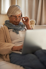 Image showing Senior woman, laptop and internet for website in home, retirement planning and glasses for reading. Elderly female person, online and networking or browse on blog, relax and pension for investment