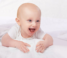 Image showing Newborn, baby and smile with laying on bed for playful, fun and laugh in bedroom at house. Adorable, cute infant and relax with happiness in home child development, wellness and excited in nursery