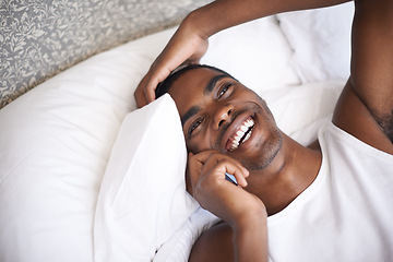 Image showing Happy, black man and lying in bed with phone for communication, conversation or networking at home. Face of African male person with smile on mobile smartphone for discussion or relax in the bedroom