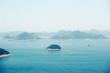 Image showing Ocean, nature and aerial of island for travel, holiday and vacation destination in summer. Natural background, seascape and rock islands in water for scenic view in environment, ecosystem and waves