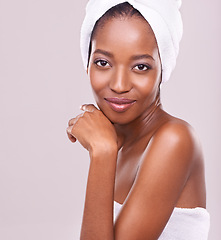 Image showing Woman, face and towel for beauty in studio with skincare, dermatology and self care on a white background. Portrait of a young model or African person with smile for hygiene, cosmetics or cosmetology