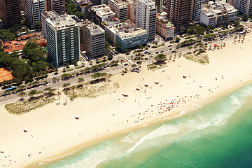 Image showing Drone, beach and cityscape or sand with landscape for travel location, holiday and vacation in rio de janeiro. Aerial view, skyscraper and tourist on ocean in summer with street, water and waves