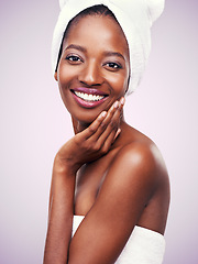 Image showing Woman, portrait and towel for beauty in studio with skincare, dermatology and self care on a pink background. Face of a young model or African person with smile for hygiene, cosmetics or cosmetology