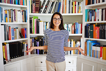 Image showing Woman, portrait and confidence by bookshelf in home with books for reading, learning or knowledge in living room. Person, face and happy by library in house with magazine, journal or study collection
