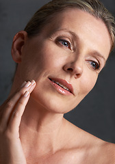 Image showing Face, skincare and memory with mature woman in studio on gray background for aesthetic wellness. Beauty, facial and thinking with natural skin person at spa for antiaging cosmetics or treatment