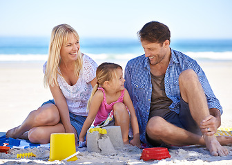 Image showing Mom, dad and girl with sandcastle by ocean on vacation with care, learning or building on holiday in summer. Father, mother and daughter with plastic bucket at beach for game, blanket or happy by sea