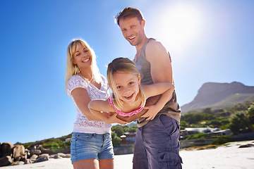 Image showing Parents, swing and playing with girl at beach in portrait with care, love and bonding in summer on holiday. Father, mother and daughter with games, connection and seaside with sunshine on vacation