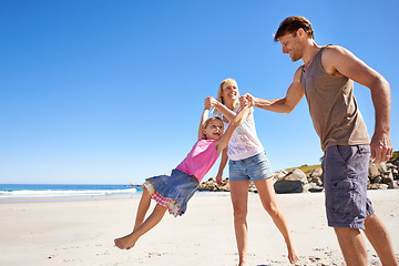 Image showing Happy family, swing and holding hands at a beach with love, support and care while bonding in nature. Freedom, travel and kid with parents at the ocean for morning games, fun or adventure at the sea