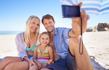 Image showing Happy family, beach and relax with selfie for picture, moment or photography in outdoor nature. Mother, father and child with smile for photo, camera or bonding memory together on the ocean coast