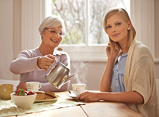 Image showing Home, portrait and woman with grandmother for tea at brunch for bonding or visit in retirement. Senior, grandma and coffee break with food, conversation and pouring liquid with steam in morning