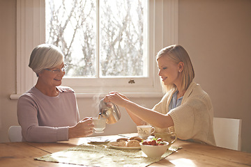 Image showing Happy, grandmother and woman with tea in home for brunch, bonding or visit in retirement. Senior, grandma and girl on coffee break with food, conversation and pouring liquid with steam in morning