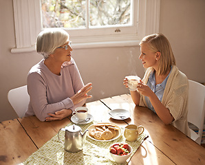 Image showing Talking, grandmother and woman with tea in home for brunch, bonding or visit in retirement. Senior, grandma and girl on coffee break with food, conversation and relax on holiday or vacation morning