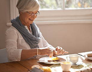 Image showing Senior, woman and eating breakfast in home with bread, cheese and tea with happiness by table in the morning. Elderly, person and smile with lunch, snack or food for nutrition and meal in dining room