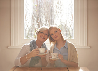 Image showing Portrait, happy woman and elderly mother drinking tea at breakfast in the morning, bonding and smile in house. Face, senior mom and daughter with coffee cup at table, love and family at home together