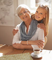 Image showing Senior woman, daughter and portrait in lounge with tea for hug, visit and retirement. Elderly pensioner, grandmother and lady with smile in home for affection together with love and gesture of touch