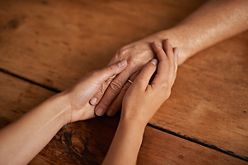 Image showing Closeup, people and hands with empathy or support for grief, comfort and compassion by table in home. Sympathy, family and praying together for gratitude, healing and kindness with trust and care