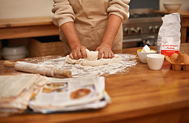 Image showing Chef, recipe and hands with dough on table, baking in kitchen and closeup on process in bakery. Person, prepare and knead bread with flour, meal prep and working with information guide from book