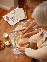 Image showing Above, people and hands baking with dough on table in kitchen and helping process in bakery. Family, prepare and press pastry in dish with flour, meal prep and work with information guide from book