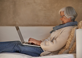 Image showing Senior woman, laptop and couch in home, technology or internet for connection. Computer, media or website for elderly blogger and writer, living room and typing happy female person in family house