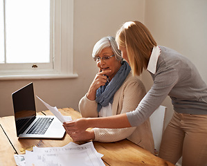 Image showing Granddaughter, grandmother and help with laptop for budget, finance and technology with advice and assistance. Women pay bills online, life insurance or tax paperwork with retirement and discussion