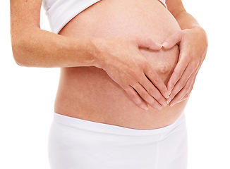 Image showing Woman, hands and heart with pregnancy in studio on white background for care, love and wellness for health. Closeup, female person and mother with maternity for childbirth and future family.