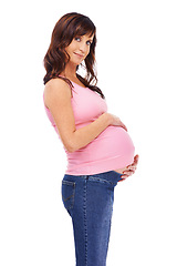 Image showing Portrait, woman and pregnant in studio smile, face and touching belly with happiness. Female person, maternity and relax on white background with casual outfit, trendy and stylish for fashion