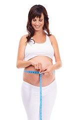Image showing Woman, smile and pregnant with measure for growth in studio on white background for, happiness, wellness and health. Maternity, mother and isolated with pregnancy for childbirth and future family.