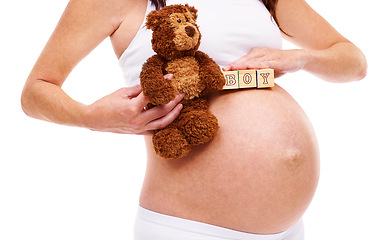 Image showing Woman, pregnant and teddy bear with blocks in studio for announcement, gender reveal and future son. Mother, belly and abdomen with growth for childcare, wellness and maternity on white background