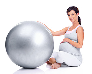 Image showing Pregnant female person, ball and studio for final trimester, wellness and exercise for motherhood. Maternal woman, workout and white background for health, fitness and pregnancy to keep in shape