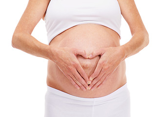 Image showing Woman, hands and heart with pregnancy in studio on white background for bonding, affection and wellness for health. Closeup, mother and maternity for pregnant mom with future family and health.